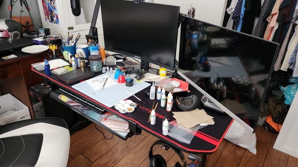 AI caption: a desk with a monitor, keyboard, mouse, and other items, black and white