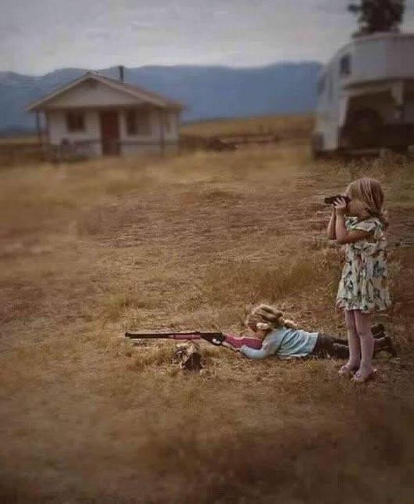 AI caption: two girls with rifles in the field, portrait