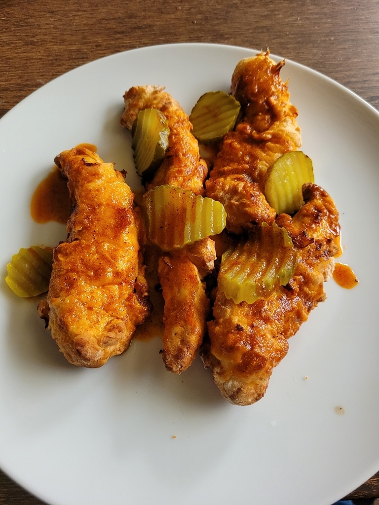 AI caption: a plate with chicken wings and pickles on it, black and white