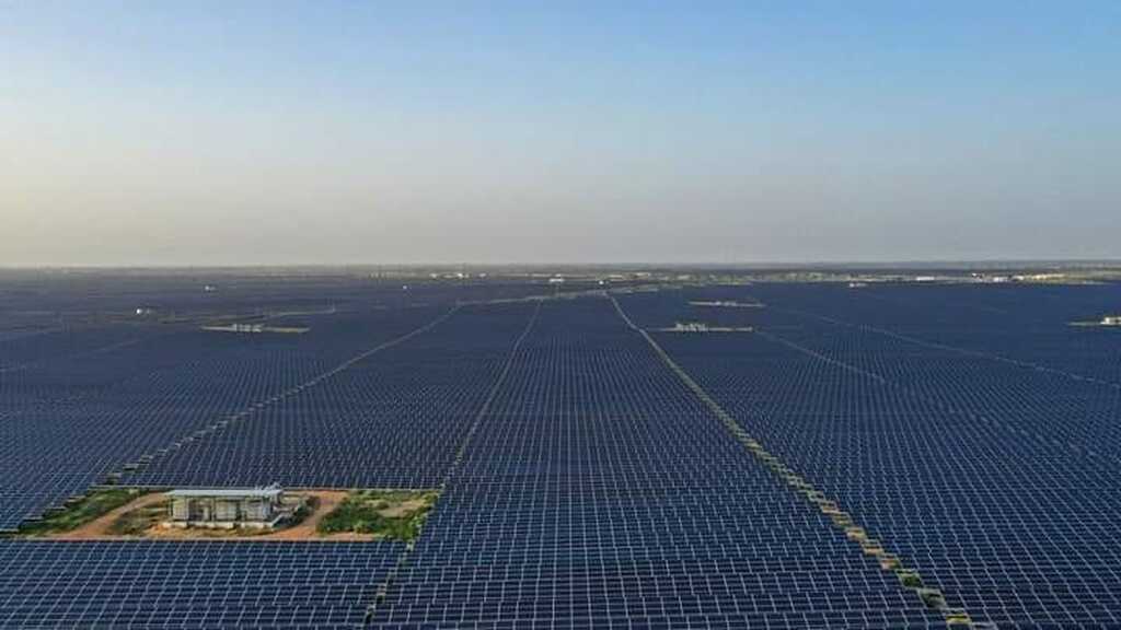 AI caption: a large solar field with many panels, aerial