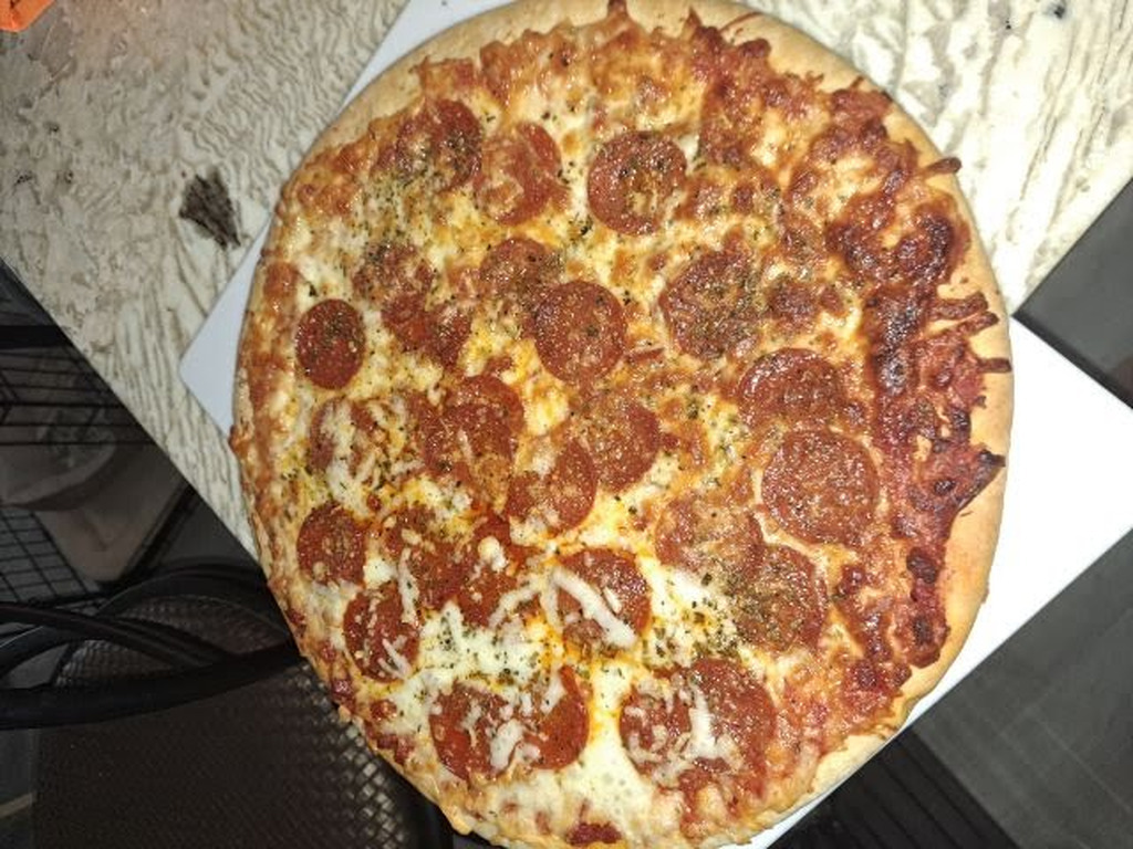 AI caption: a pizza with pepperoni on top of a white plate, black and white