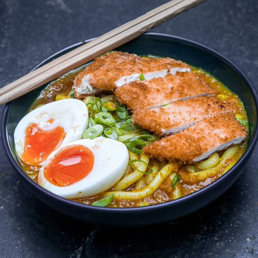 AI caption: a bowl of ramen with chicken and egg, black and white