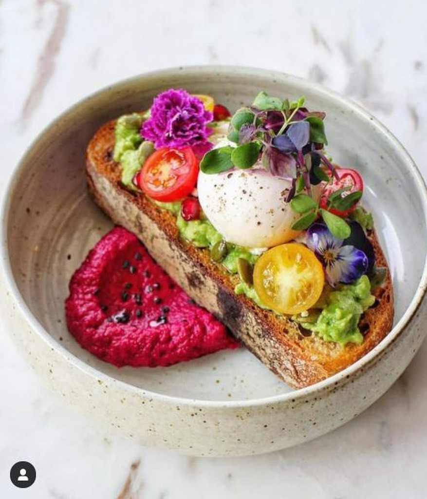 AI caption: a bowl of toast with a poached egg and a beetroot sauce, black and white