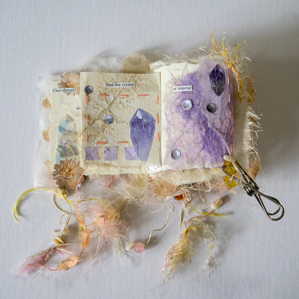 AI caption: a book with a purple cover and feathers, collage