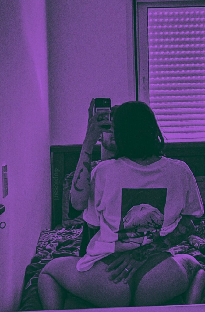 AI caption: a woman is taking a selfie in a purple bedroom, a portrait