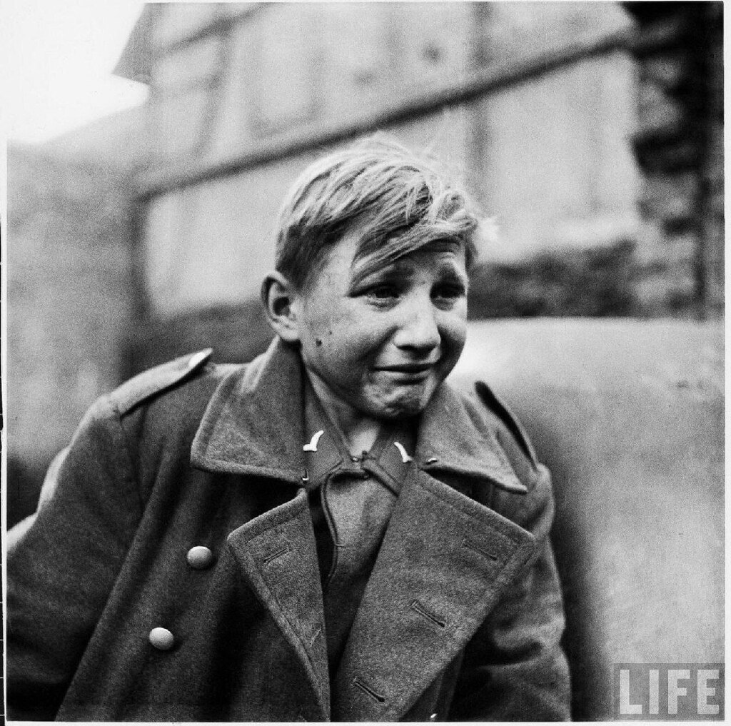 AI caption: a boy in a military uniform is smiling, black and white