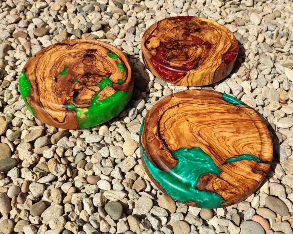 AI caption: three wooden plates with different colors on them, natural three wooden coasters with different colors on them