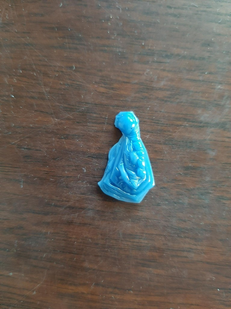 AI caption: a blue figurine on a wooden table, a 3d printed image