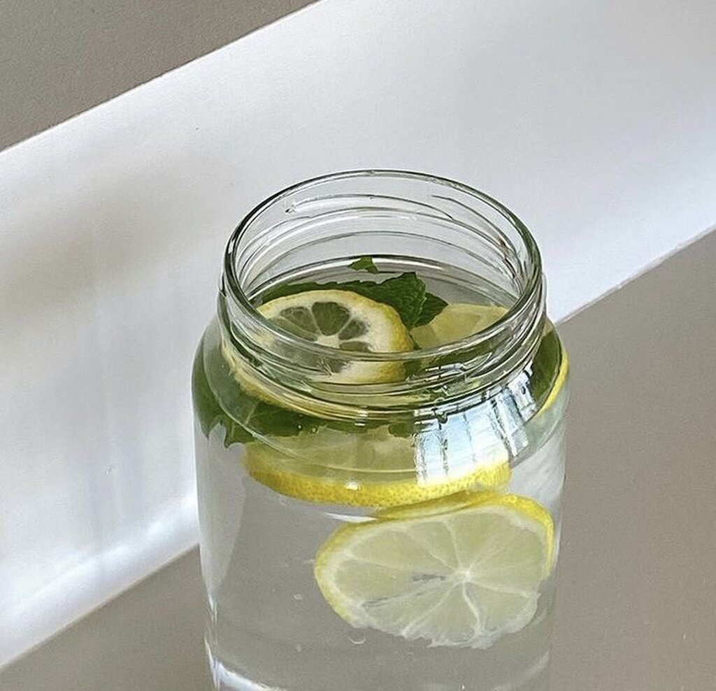 AI caption: a jar of water with lemon slices and mint, flat