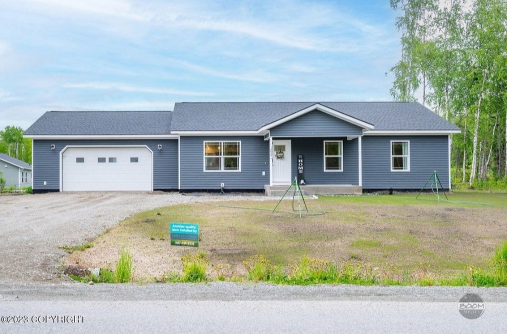 AI caption: a house with a garage and grass in front, modern
