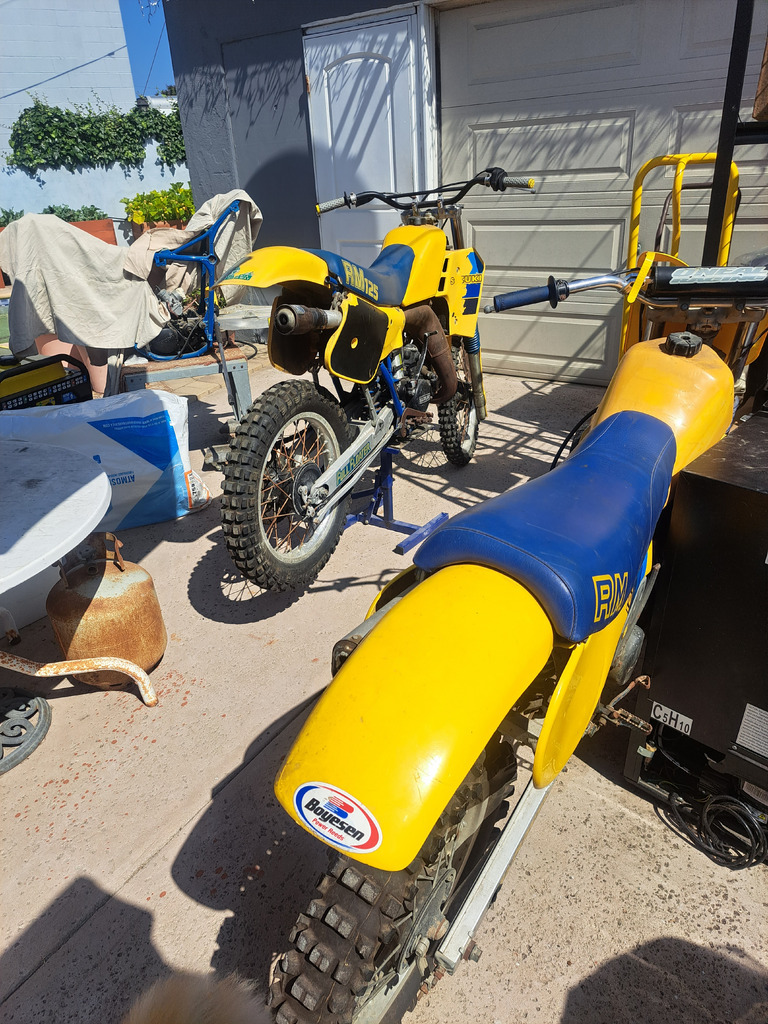 AI caption: a yellow dirt bike parked in a garage, a street scene