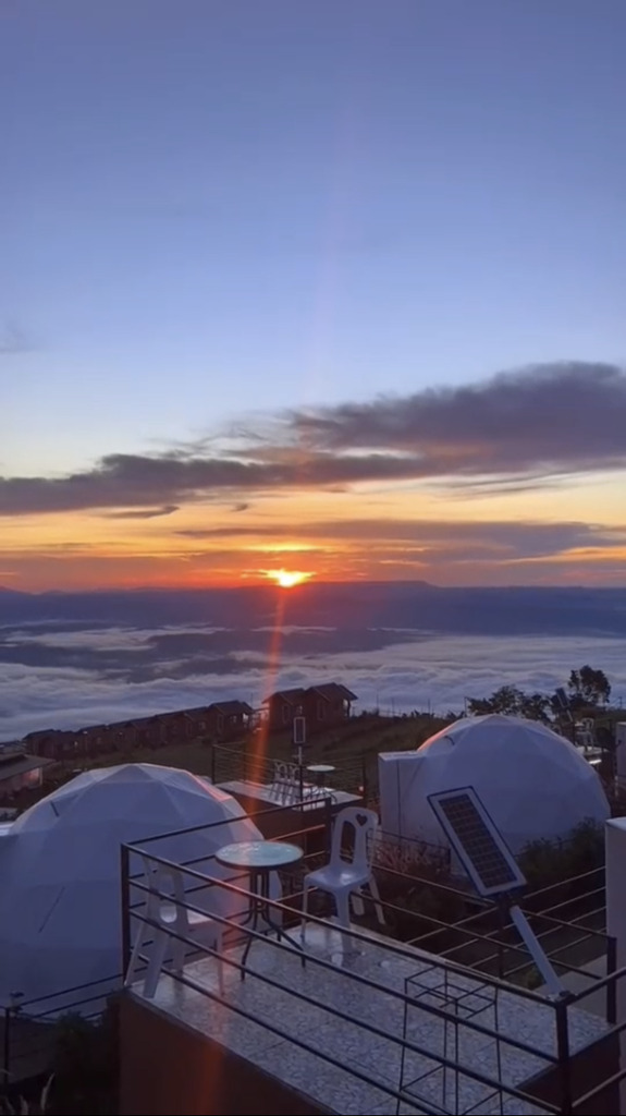 AI caption: a view of the sun setting over a group of domes, panoramic