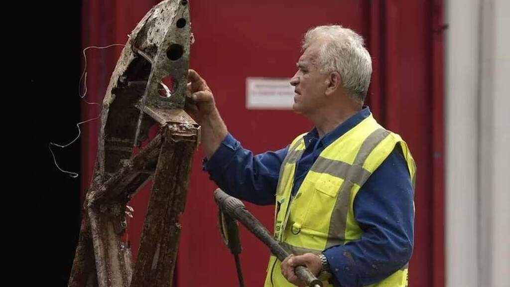 AI caption: the man is pointing at the plane
