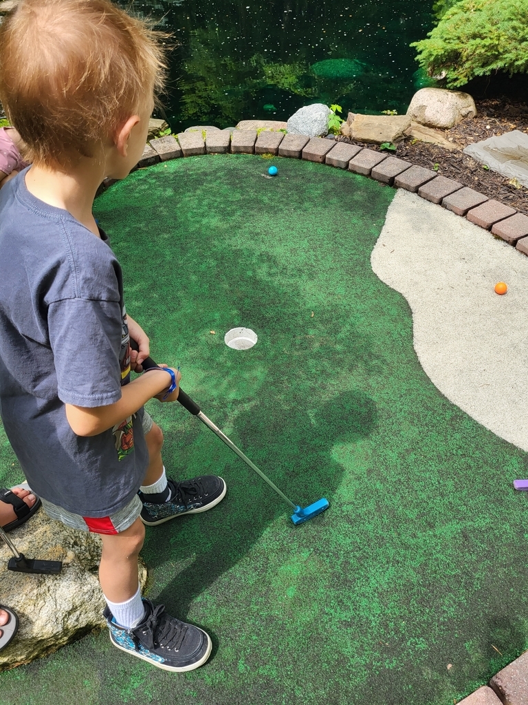 AI caption: a boy is playing mini golf with a ball, cartoon