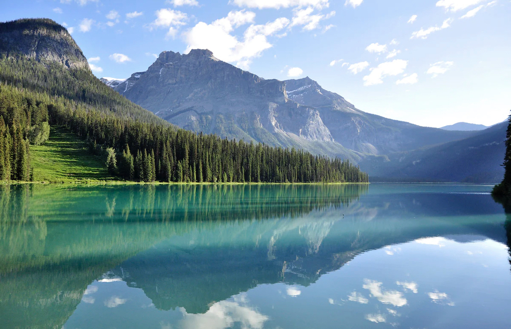 AI caption: a lake surrounded by mountains and trees, abstract