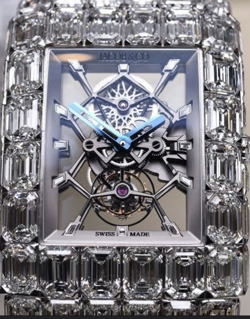 AI caption: a person holding a watch with a diamond bezel, a watch a watch with a large number of diamonds