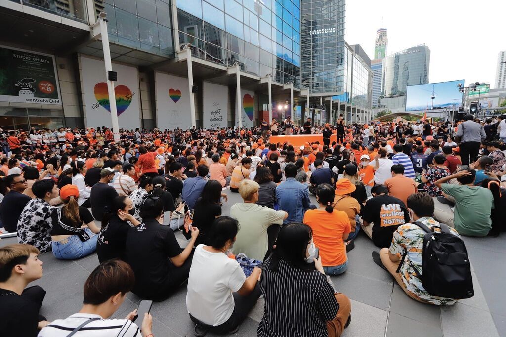 AI caption: the image is a satire of the muslim community, the woman is wearing a hat with a picture of a man, portrait a woman is taking a picture with a camera, the woman is wearing a t shirt that says 'i am a woman', portrait