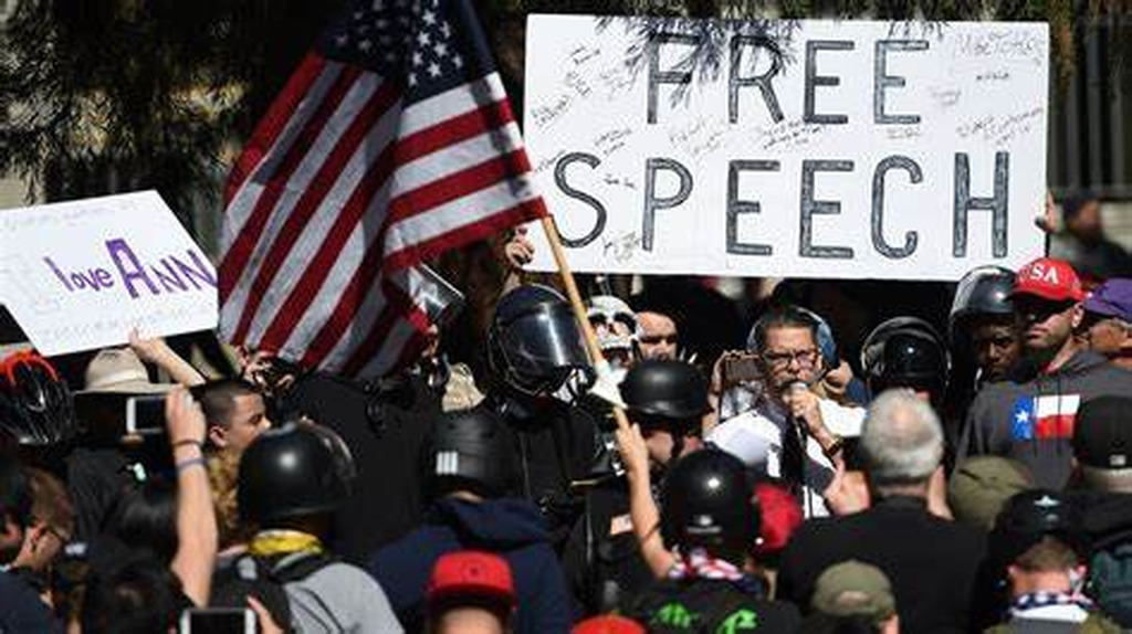 AI caption: a group of people holding signs with the word free speech, graphic