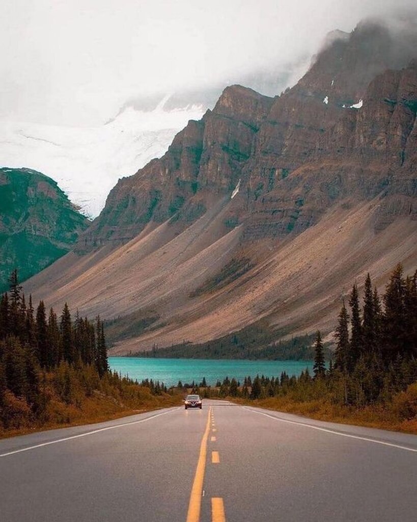 AI caption: a car driving down a road in the mountains, landscape