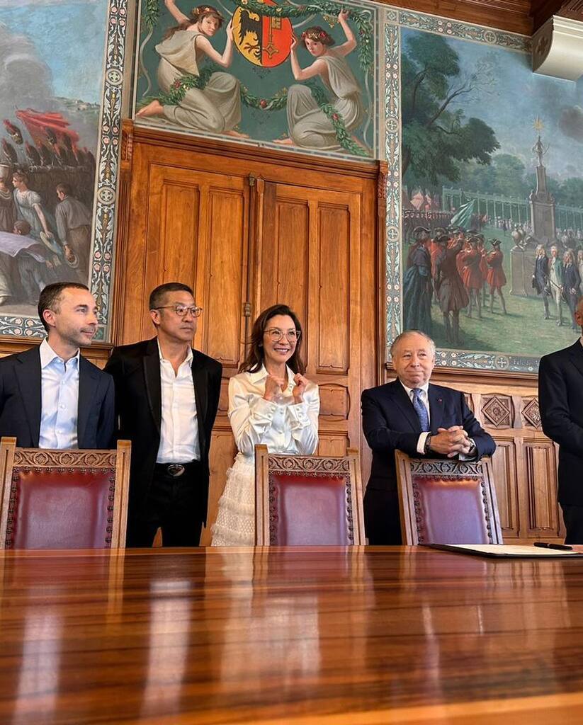 AI caption: a woman holding a framed poster of love never dies, portrait a couple laying in bed with swans on the bed, the couple is posing in bed, romantic a group of people standing around a table, the people are standing in front of a painting